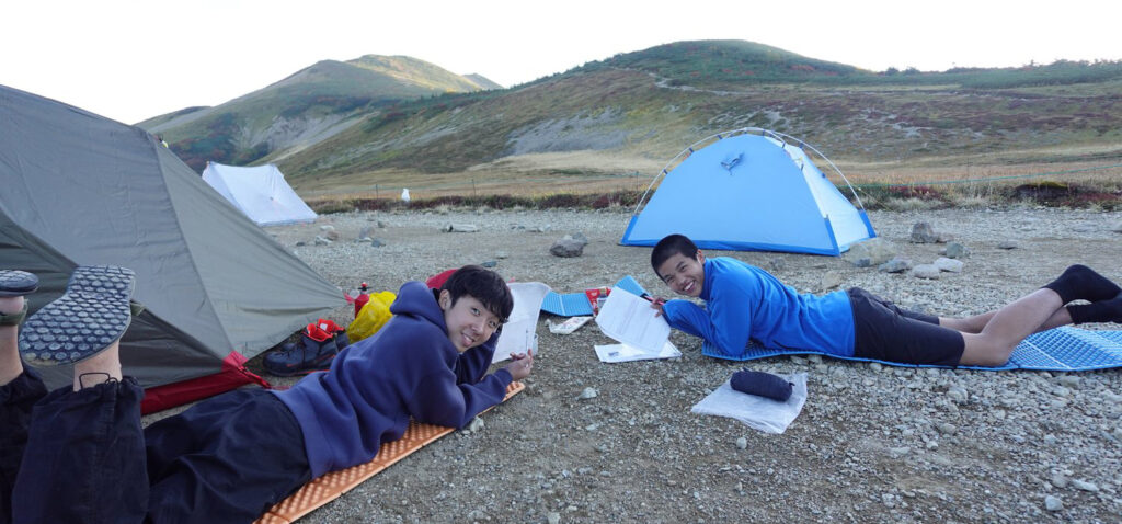 Students on a camping trip at Hakuba International School taking part in outdoor learning.